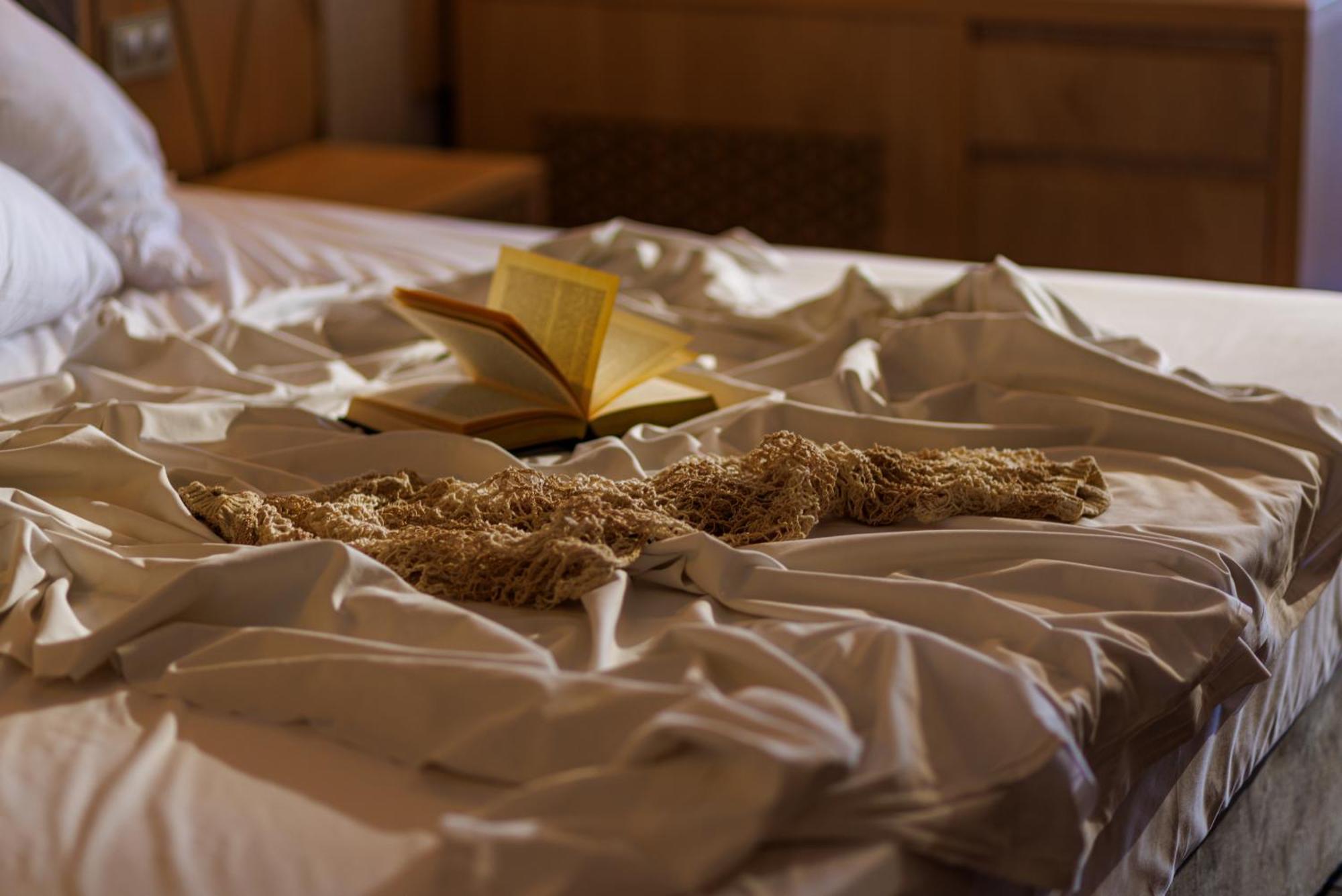 Secrets Sunny Beach Resort & Spa (Adults Only) 외부 사진 A bed with a book and a cat